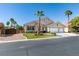 Charming single-story home with a three-car garage and well-manicured lawn and mature palm trees at 2543 Farmington Ave, Las Vegas, NV 89120