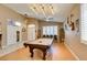 Well-lit game room features wood floors, a pool table, and easy access to other rooms in the house at 2543 Farmington Ave, Las Vegas, NV 89120
