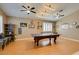Spacious game room with a pool table, wood floors, and ample lighting fixtures at 2543 Farmington Ave, Las Vegas, NV 89120