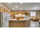Bright kitchen featuring wooden cabinets, tiled floor, and a white countertop island at 2543 Farmington Ave, Las Vegas, NV 89120