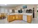 Spacious kitchen with white countertops, wooden cabinets, and open dining area at 2543 Farmington Ave, Las Vegas, NV 89120