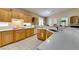 Sunlit kitchen equipped with wooden cabinets, white countertops, and stainless steel appliances at 2543 Farmington Ave, Las Vegas, NV 89120