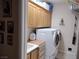 Bright laundry room features cabinets for storage and a modern washer and dryer set at 2543 Farmington Ave, Las Vegas, NV 89120