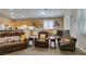 Cozy living room with comfortable seating, a kitchen view, and ample natural light at 2543 Farmington Ave, Las Vegas, NV 89120