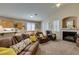 Inviting living room features plush seating, a fireplace, and natural light from shuttered windows at 2543 Farmington Ave, Las Vegas, NV 89120