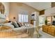 Inviting main bedroom with a jacuzzi tub, plenty of natural light, and soft color palette at 2543 Farmington Ave, Las Vegas, NV 89120