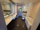 Spa-like bathroom featuring a double sink vanity, soaking tub, and glass-enclosed shower at 2600 W Harmon Ave # 20034, Las Vegas, NV 89158