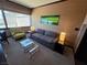 Modern living room with a comfortable gray sofa, stylish green artwork, and bright lamps at 2600 W Harmon Ave # 20034, Las Vegas, NV 89158