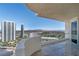 Enjoy city views from this condo balcony, featuring glass railings and tile floors with a golf course in the background at 2777 Paradise Rd # 2605, Las Vegas, NV 89109