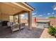 Relaxing covered patio featuring comfortable lounge chairs and a hot tub, ideal for enjoying the outdoors at 2902 Ventana Ridge Ave, Henderson, NV 89044