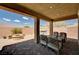 Relaxing covered patio with comfortable seating and a hot tub, perfect for enjoying outdoor living at 2902 Ventana Ridge Ave, Henderson, NV 89044