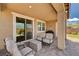 Cozy covered patio with outdoor seating, seamlessly connected to the interior through sliding glass doors at 2902 Ventana Ridge Ave, Henderson, NV 89044