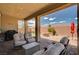 Charming covered patio with outdoor seating and a cozy fire pit, perfect for entertaining friends and Gathering at 2902 Ventana Ridge Ave, Henderson, NV 89044