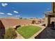 Private backyard with an artificial lawn, brick patio, firepit, and spa; perfect for outdoor entertaining at 2902 Ventana Ridge Ave, Henderson, NV 89044