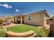 Expansive backyard with a covered patio, fire pit, and manicured landscaping, creating an inviting outdoor space at 2902 Ventana Ridge Ave, Henderson, NV 89044