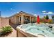 Beautiful backyard with a luxurious hot tub, covered patio, and manicured landscaping, creating a private oasis at 2902 Ventana Ridge Ave, Henderson, NV 89044