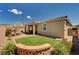 Lush backyard featuring a covered patio, fire pit, and well-maintained lawn, offering a perfect outdoor retreat at 2902 Ventana Ridge Ave, Henderson, NV 89044