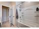 Bathroom features a shower and tub combo with tiled walls and laminate flooring at 2902 Ventana Ridge Ave, Henderson, NV 89044
