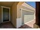 View of front door and two car garage with brick paver driveway at 2902 Ventana Ridge Ave, Henderson, NV 89044