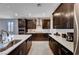 Stylish kitchen with stainless steel appliances, white countertops, and ample dark wood cabinetry at 2902 Ventana Ridge Ave, Henderson, NV 89044