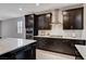 Modern kitchen features stainless steel appliances, dark cabinets, and a sleek cooktop at 2902 Ventana Ridge Ave, Henderson, NV 89044