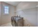 Laundry room features tile floors, a window and modern washer and dryer at 2902 Ventana Ridge Ave, Henderson, NV 89044