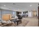 Open living space with modern decor, comfortable seating, and a view of the kitchen area at 2902 Ventana Ridge Ave, Henderson, NV 89044