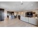 Open-concept living area with kitchen island, wood floors, and a modern entertainment center at 2902 Ventana Ridge Ave, Henderson, NV 89044