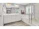 Modern bathroom with double sinks, a soaking tub, and a glass-enclosed shower at 3002 Coveri Ct, Las Vegas, NV 89141