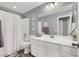 Bright bathroom featuring white cabinetry, a shower-tub combo, and modern fixtures at 3002 Coveri Ct, Las Vegas, NV 89141