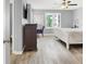 Bright bedroom showcasing wood-look flooring, a ceiling fan, and abundant natural light at 3002 Coveri Ct, Las Vegas, NV 89141