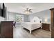Comfortable bedroom featuring wood-look flooring, a ceiling fan, and stylish furnishings at 3002 Coveri Ct, Las Vegas, NV 89141