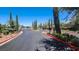 Gated entrance to a residential community with sidewalks and landscaping on either side at 3002 Coveri Ct, Las Vegas, NV 89141