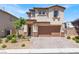 Two-story home featuring a brown garage door, stucco siding, and landscaped front yard at 3002 Coveri Ct, Las Vegas, NV 89141
