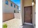 Inviting entrance with a wooden door and a decorative outdoor light fixture at 3002 Coveri Ct, Las Vegas, NV 89141