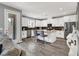 Modern kitchen featuring white cabinets, an island with seating, and stainless steel appliances at 3002 Coveri Ct, Las Vegas, NV 89141