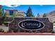 Stone entrance sign that reads 'Cortona at Southern Highlands' with lush plants in front at 3002 Coveri Ct, Las Vegas, NV 89141