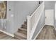 Bright staircase with wooden steps, white railing, and stylish flooring at 3002 Coveri Ct, Las Vegas, NV 89141