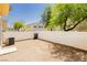 This backyard features a privacy fence, neutral paint, and an air conditioning unit at 3041 Gary Cooper St # 103, Las Vegas, NV 89122