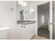 This bathroom has a white vanity with gray countertop, a toilet, and neutral-colored tiling at 3041 Gary Cooper St # 103, Las Vegas, NV 89122