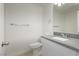 This bathroom features a white vanity with a gray countertop, a toilet, and a mirror at 3041 Gary Cooper St # 103, Las Vegas, NV 89122
