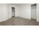 This bedroom features neutral carpeting, a walk-in closet, and a door leading to another room at 3041 Gary Cooper St # 103, Las Vegas, NV 89122