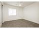 A bright bedroom features carpet, a ceiling fan, a window, and white trim and walls at 3041 Gary Cooper St # 103, Las Vegas, NV 89122