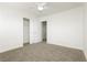 The bedroom features neutral carpeting, a ceiling fan, and a door to the closet at 3041 Gary Cooper St # 103, Las Vegas, NV 89122