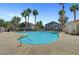 A shared community pool has a large sundeck and several mature palm trees at 3041 Gary Cooper St # 103, Las Vegas, NV 89122