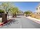 The private entrance to the community includes brick columns and mature landscaping at 3041 Gary Cooper St # 103, Las Vegas, NV 89122