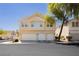 Two-story condo with a three-car garage and manicured landscaping, perfect for modern living at 3041 Gary Cooper St # 103, Las Vegas, NV 89122