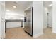 Stainless steel refrigerator next to modern kitchen countertops and cabinets at 3041 Gary Cooper St # 103, Las Vegas, NV 89122