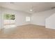 Bright living room features tile flooring, a ceiling fan, and sliding glass doors to the backyard at 3041 Gary Cooper St # 103, Las Vegas, NV 89122