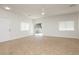 The open living room has large windows, tile floors, a ceiling fan, and backyard access at 3041 Gary Cooper St # 103, Las Vegas, NV 89122